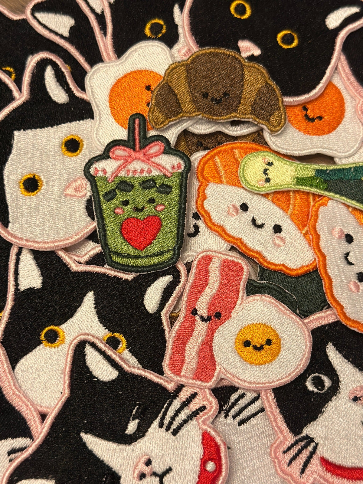 Close-up of several Urbanite embroidered patch designs for styling inspiration; only one cat patch included