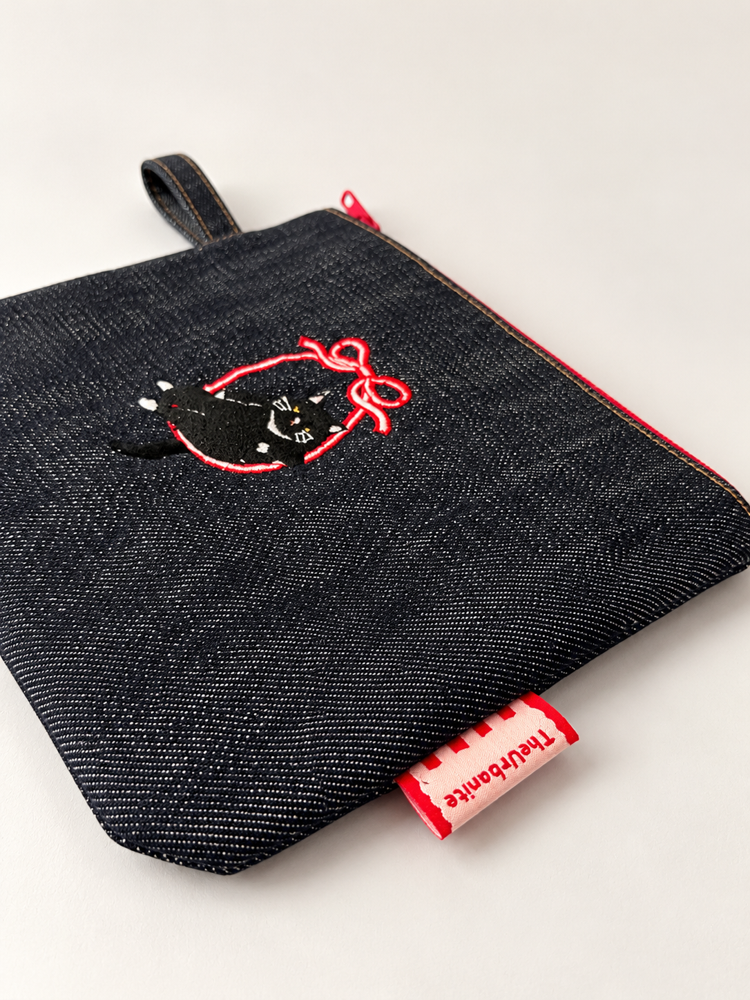 Cat 3.0 black-and-white cat embroidery and TheUrbanite label detail