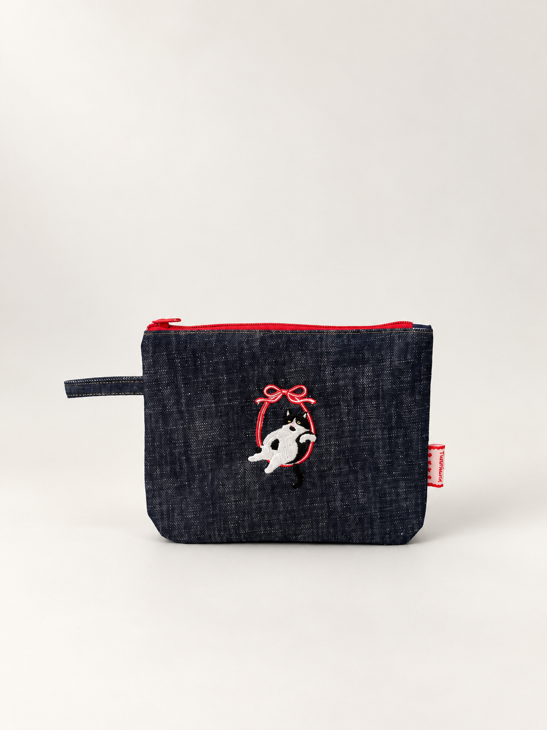 Front view of Cat Style 1 large rounded-corner denim pouch with embroidered black and white cat