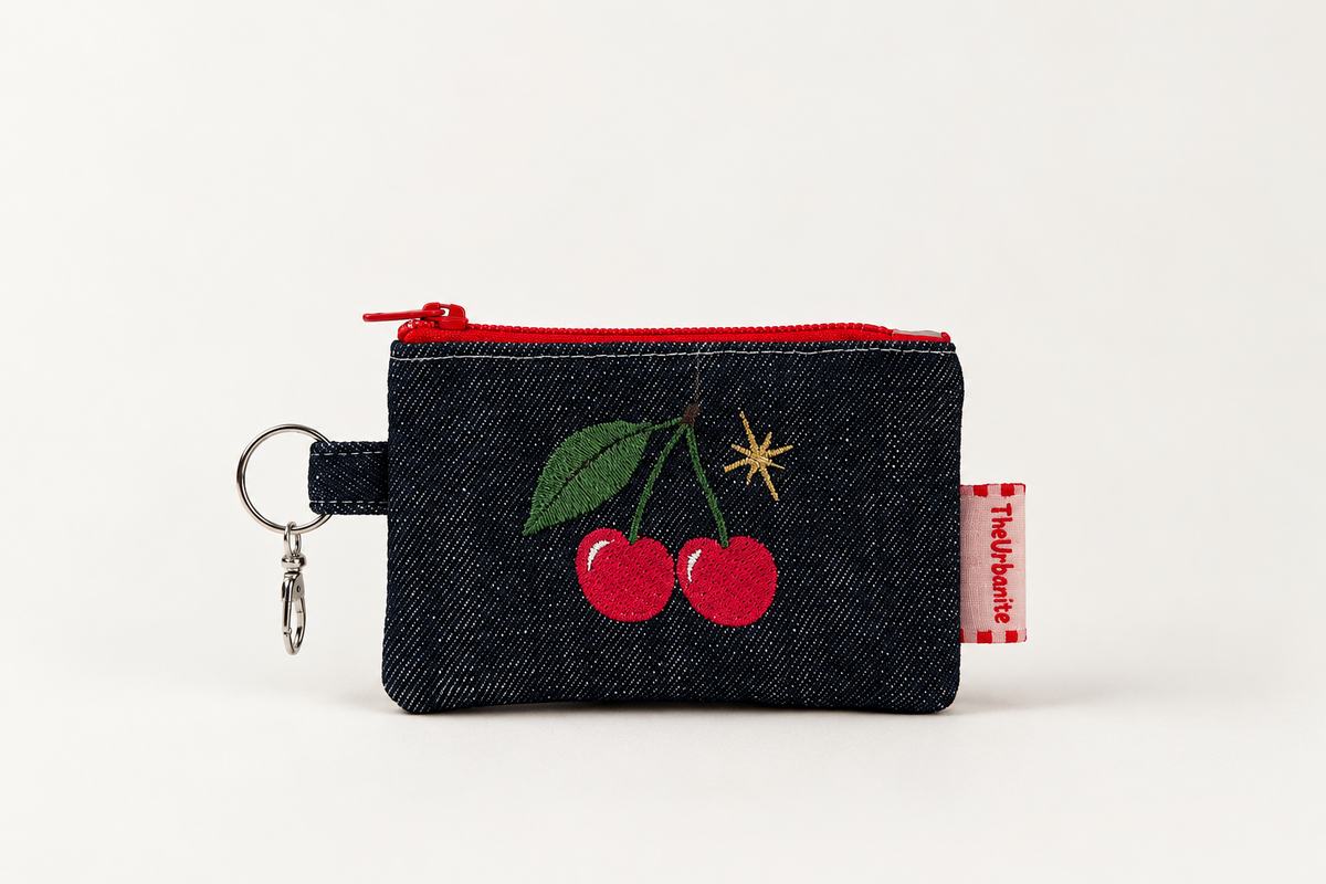 Cherry embroidered dark denim coin purse from the front, with red zipper and metal keyring