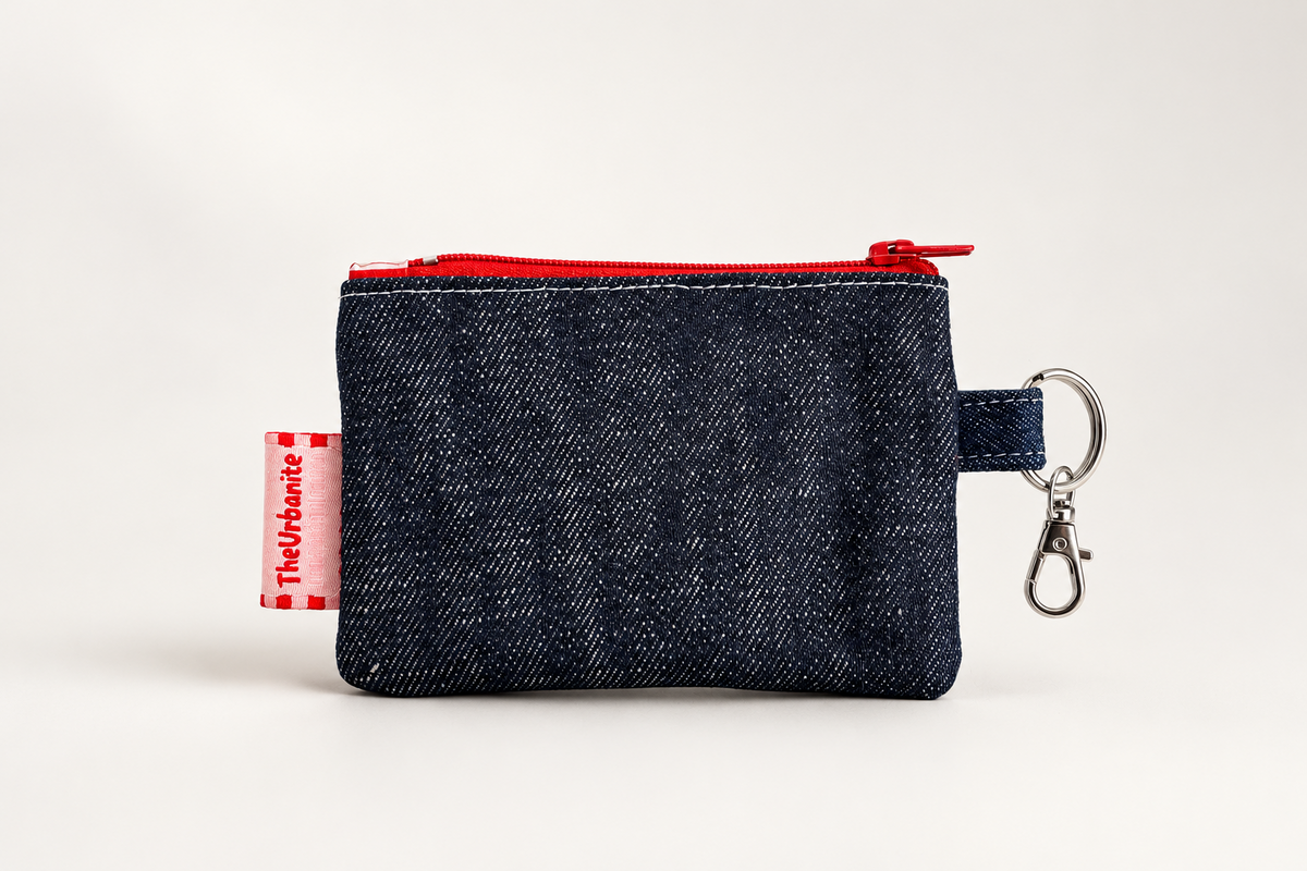 Reverse side of the dark denim cherry coin purse with red zipper, pink Urbanite label and metal keyring clasp