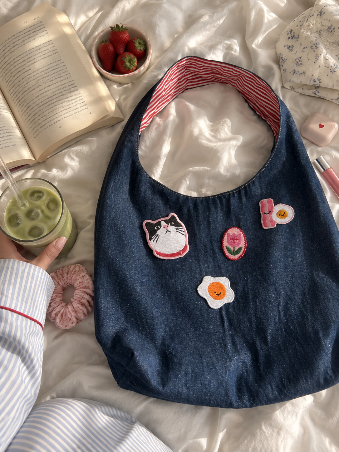 Styling example: denim hobo bag decorated with several embroidered patches; bag and additional patches not included