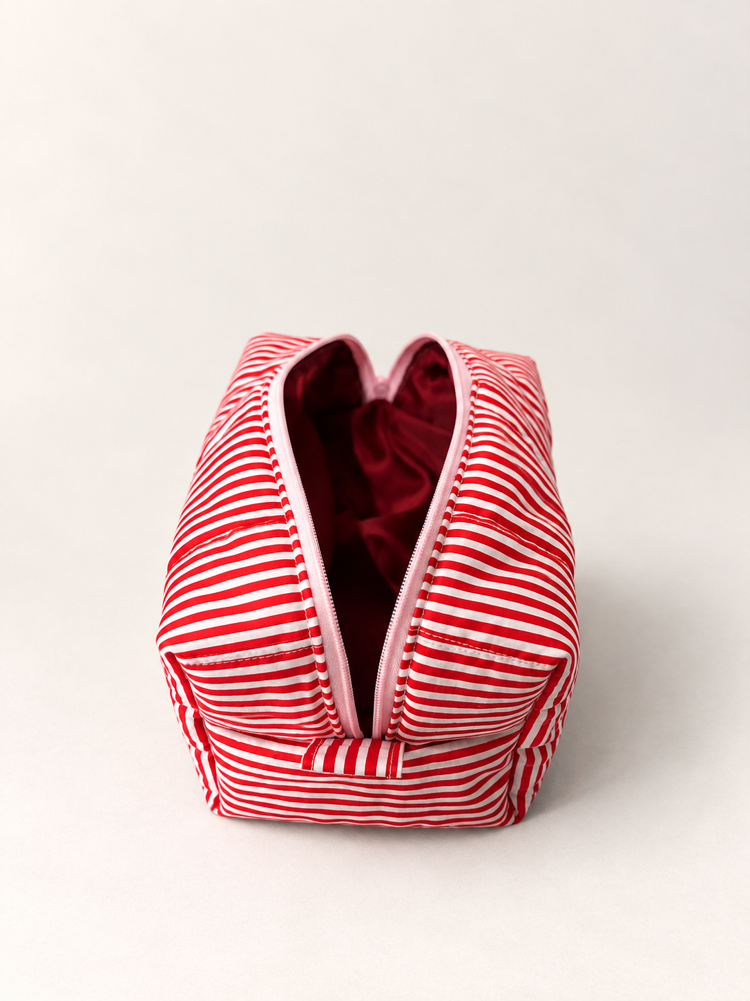 Top view of open Lucky Girl makeup bag with burgundy-coloured interior