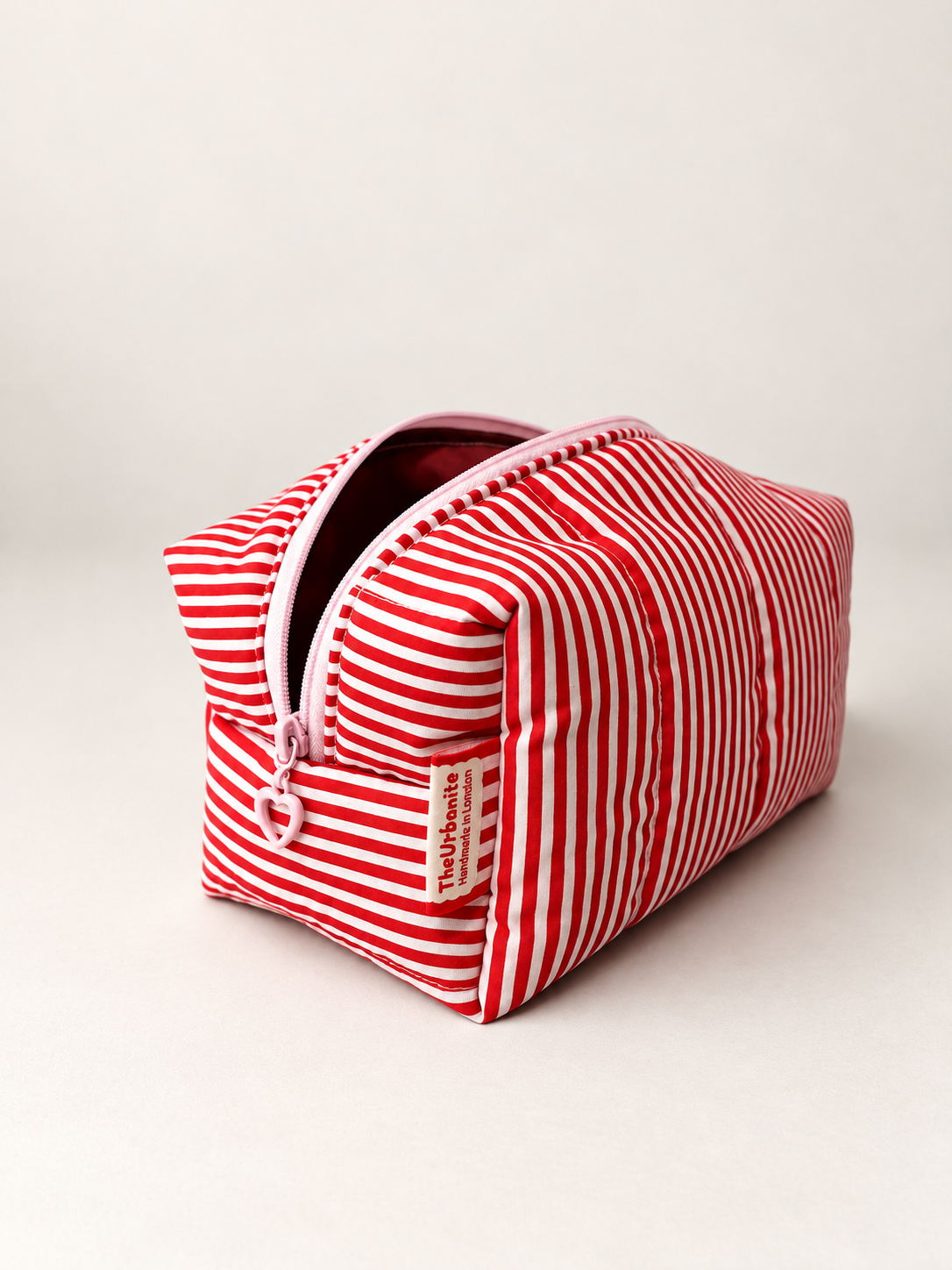 Lucky Girl makeup bag detail with slightly open pink zipper and TheUrbanite label