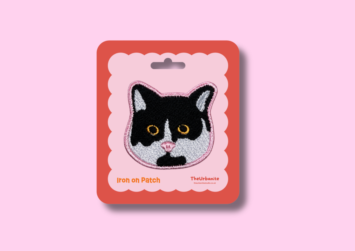 Masked Cat Iron-On Patch on pink and coral Urbanite retail backing card