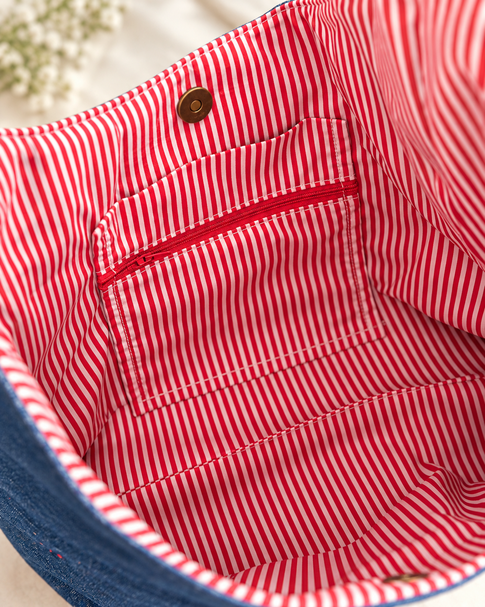 Red and white striped bag interior with zipped pocket