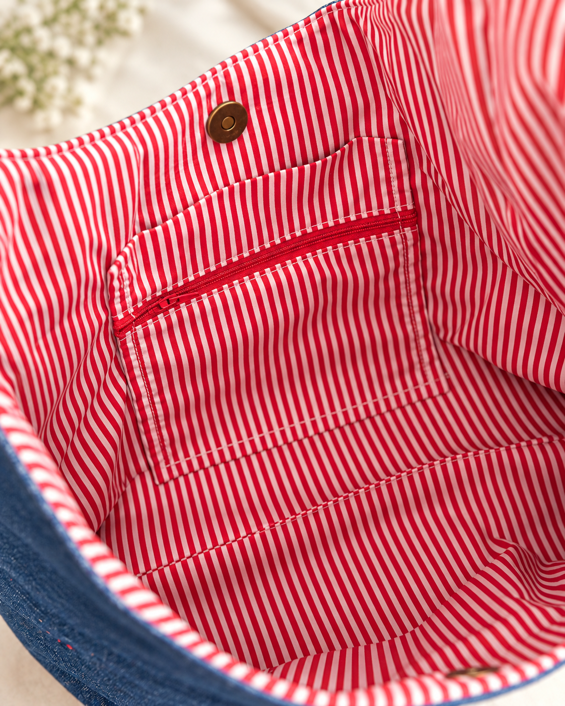 Red and white striped inside pocket and magnetic snap of Tiger Heart SOHO bag